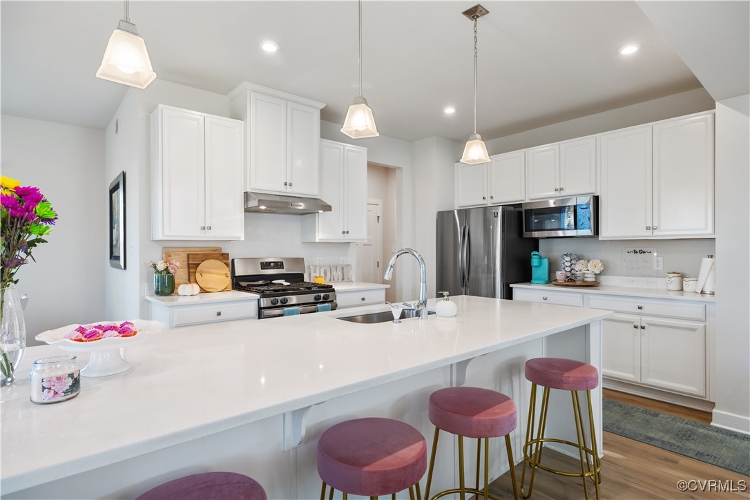 13901 Marsham Road Chester, VA 23836 - Photo 8 of 27 a kitchen with stainless steel appliances kitchen island granite countertop a sink and cabinets