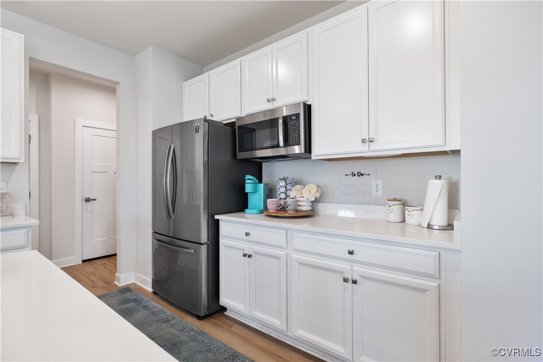 13901 Marsham Road Chester, VA 23836 - Photo 10 of 27 a kitchen with stainless steel appliances white cabinets white refrigerator and a sink