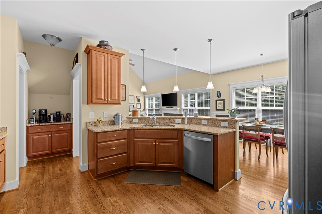 705 Wales Way Ashland, VA 23005 - Photo 17 of 62 a kitchen with stainless steel appliances granite countertop a sink and wooden floor