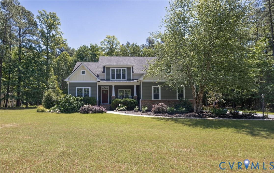 705 Wales Way Ashland, VA 23005 - Photo 2 of 62 a front view of house with yard and trees in the background