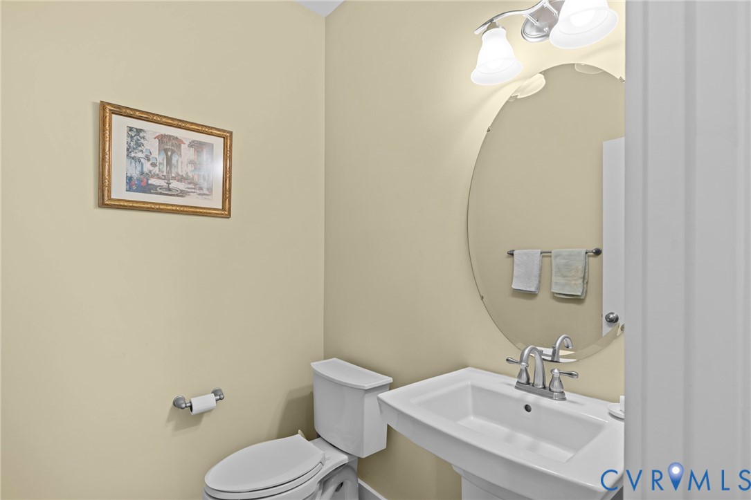 705 Wales Way Ashland, VA 23005 - Photo 22 of 62 a bathroom with a toilet sink and mirror