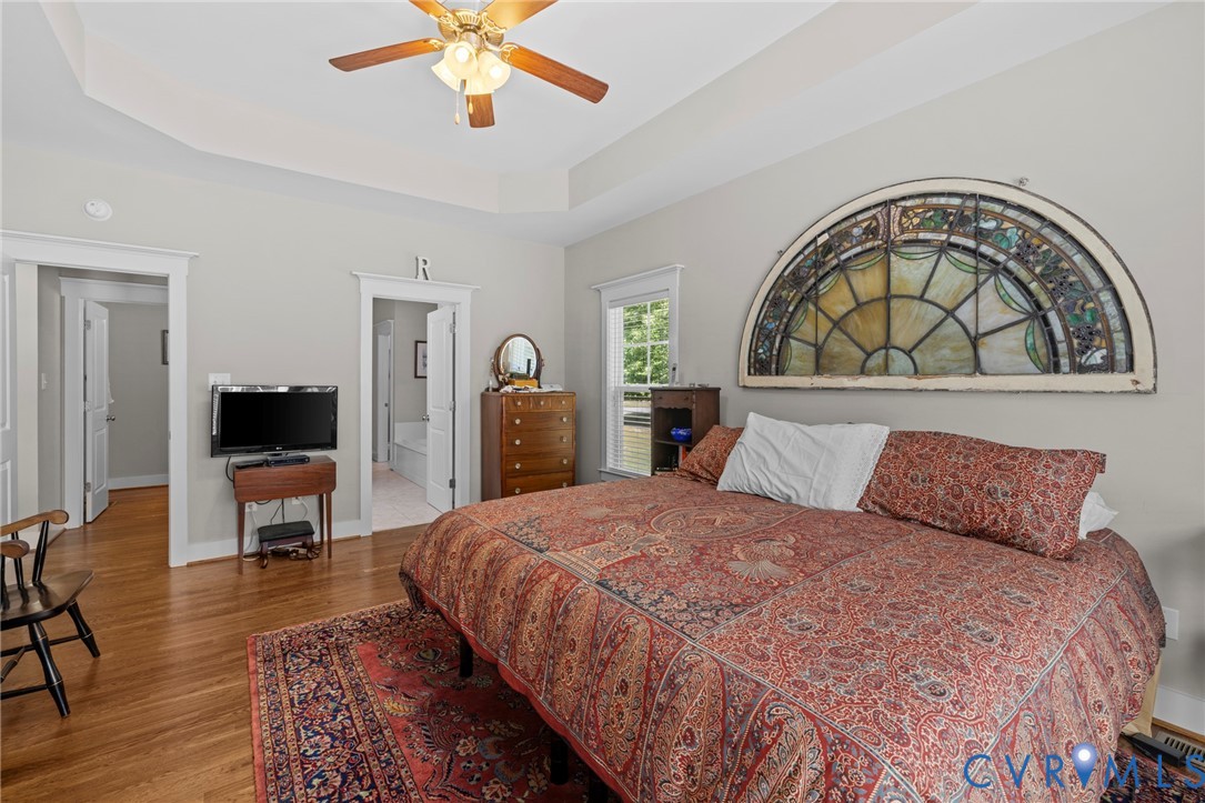 705 Wales Way Ashland, VA 23005 - Photo 24 of 62 a bedroom with a bed and a chandelier