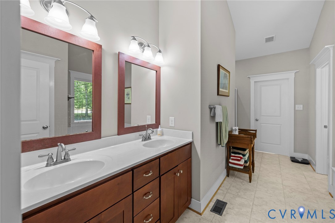 705 Wales Way Ashland, VA 23005 - Photo 25 of 62 a bathroom with a double vanity sink a mirror and a
