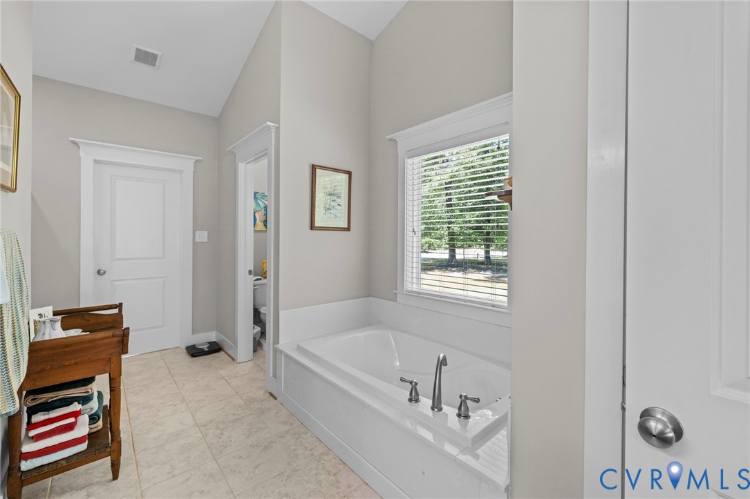 705 Wales Way Ashland, VA 23005 - Photo 26 of 62 a bathroom with a bathtub and a window