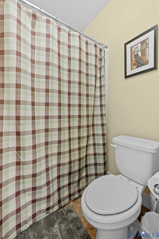 705 Wales Way Ashland, VA 23005 - Photo 39 of 62 a white toilet sitting next to a shower curtain