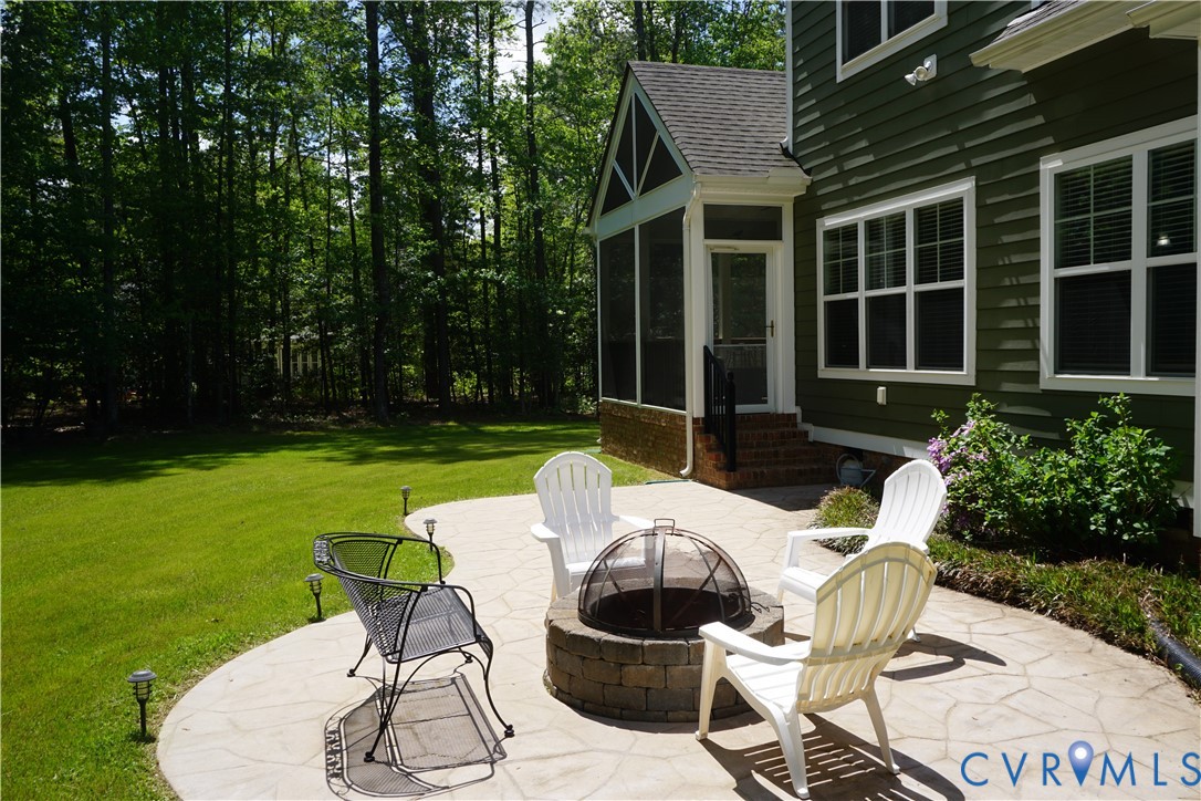 705 Wales Way Ashland, VA 23005 - Photo 44 of 62 a view of a chair and table in backyard of the house