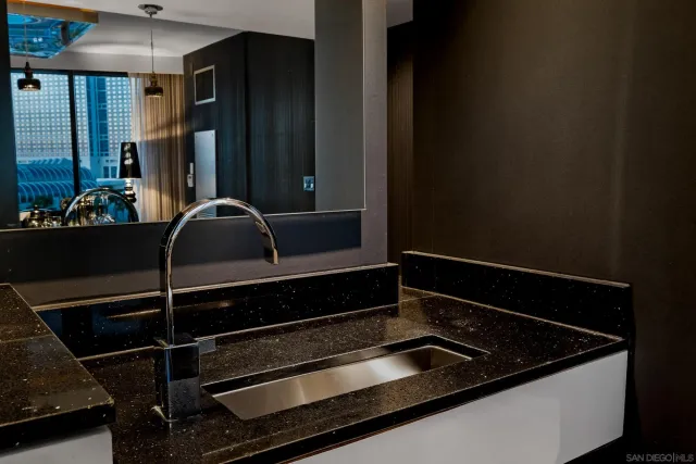 a roof deck with couches and wooden floor