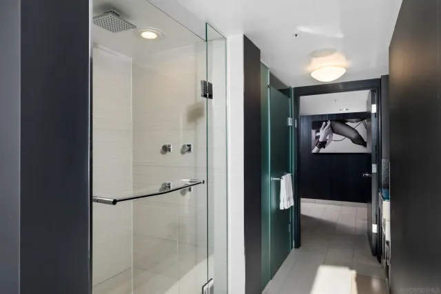 a bedroom with a bed and glass window