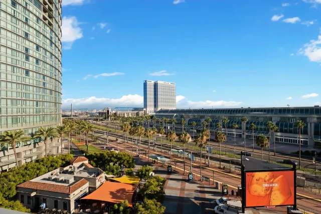 a bedroom with a large bed and a flat tv screen