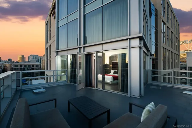 a view of a chairs and table in the balcony