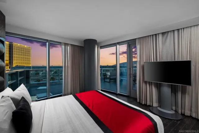 a bedroom with a bed and large window