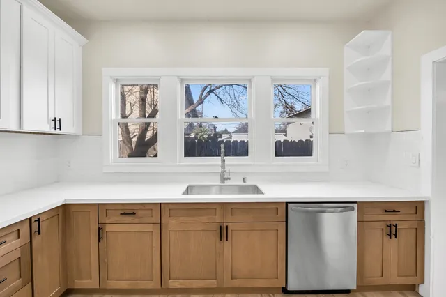 a view of a kitchen with wooden floor and a sink