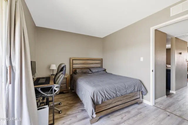 a bedroom with a bed and a desk