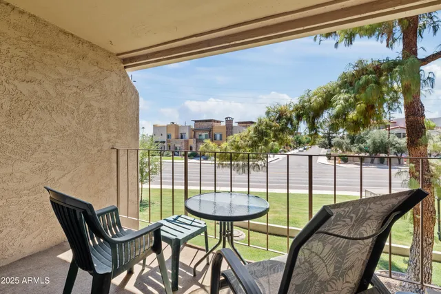 a view of a balcony with furniture