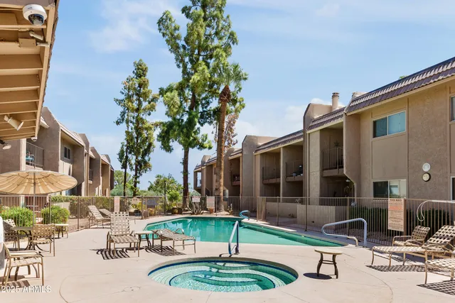 a swimming pool with outdoor seating and yard