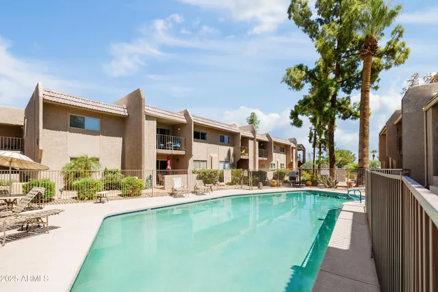 a swimming pool with outdoor seating and yard