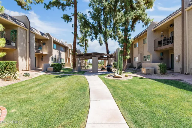 a swimming pool with outdoor seating and yard