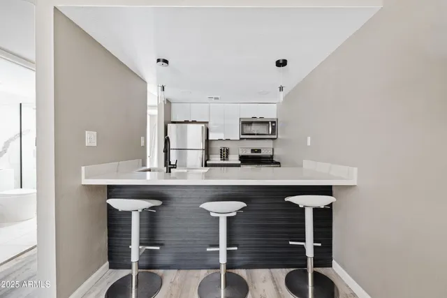 a kitchen with stainless steel appliances a sink and cabinets