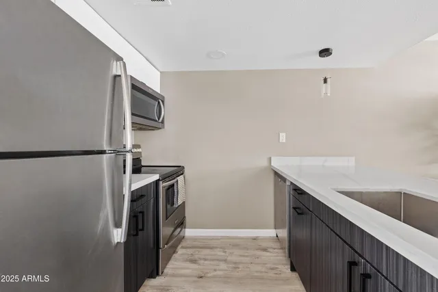 a kitchen with a sink and stainless steel appliances