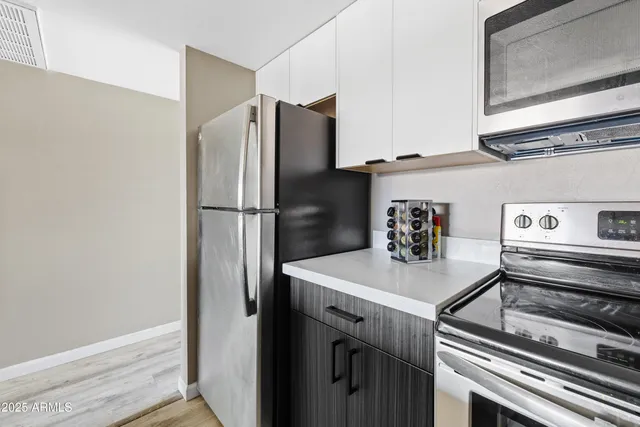a kitchen with a refrigerator and a stove