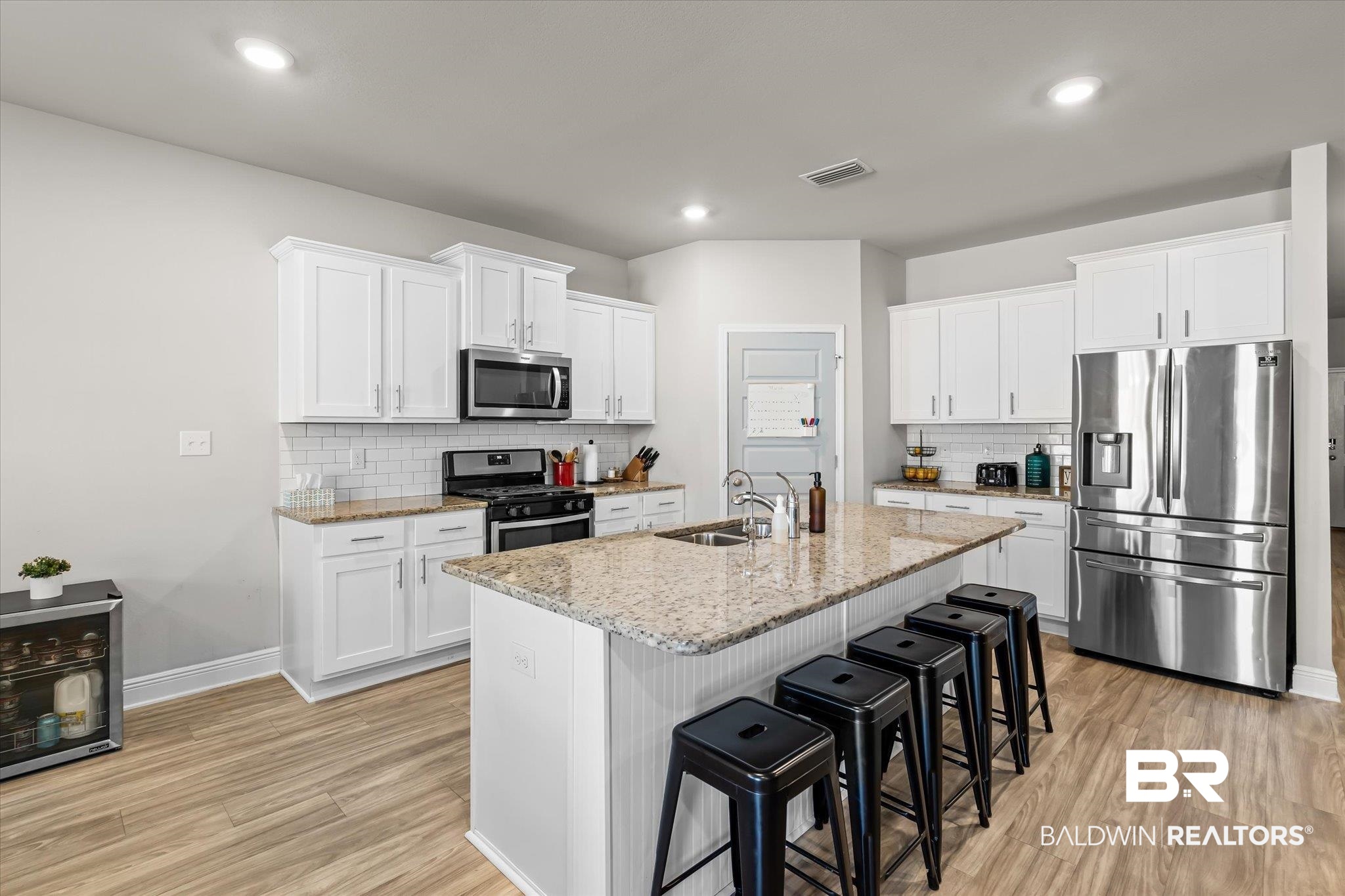 24262 Alydar Loop Daphne, AL 36526 - Photo 3 of 33 Kitchen featuring light wood-style floors, visible vents, appliances with stainless steel finishes, and a sink