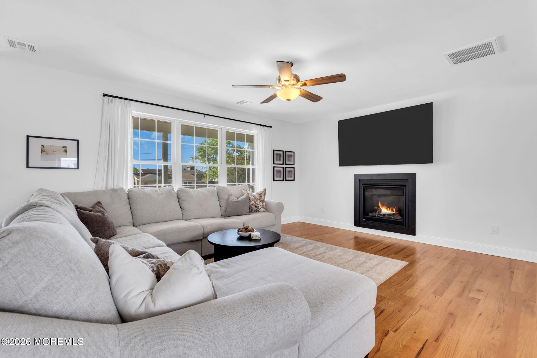 312 Beach Boulevard Forked River, NJ 08731 - Photo 12 of 40 a living room with furniture a fireplace and a flat screen tv