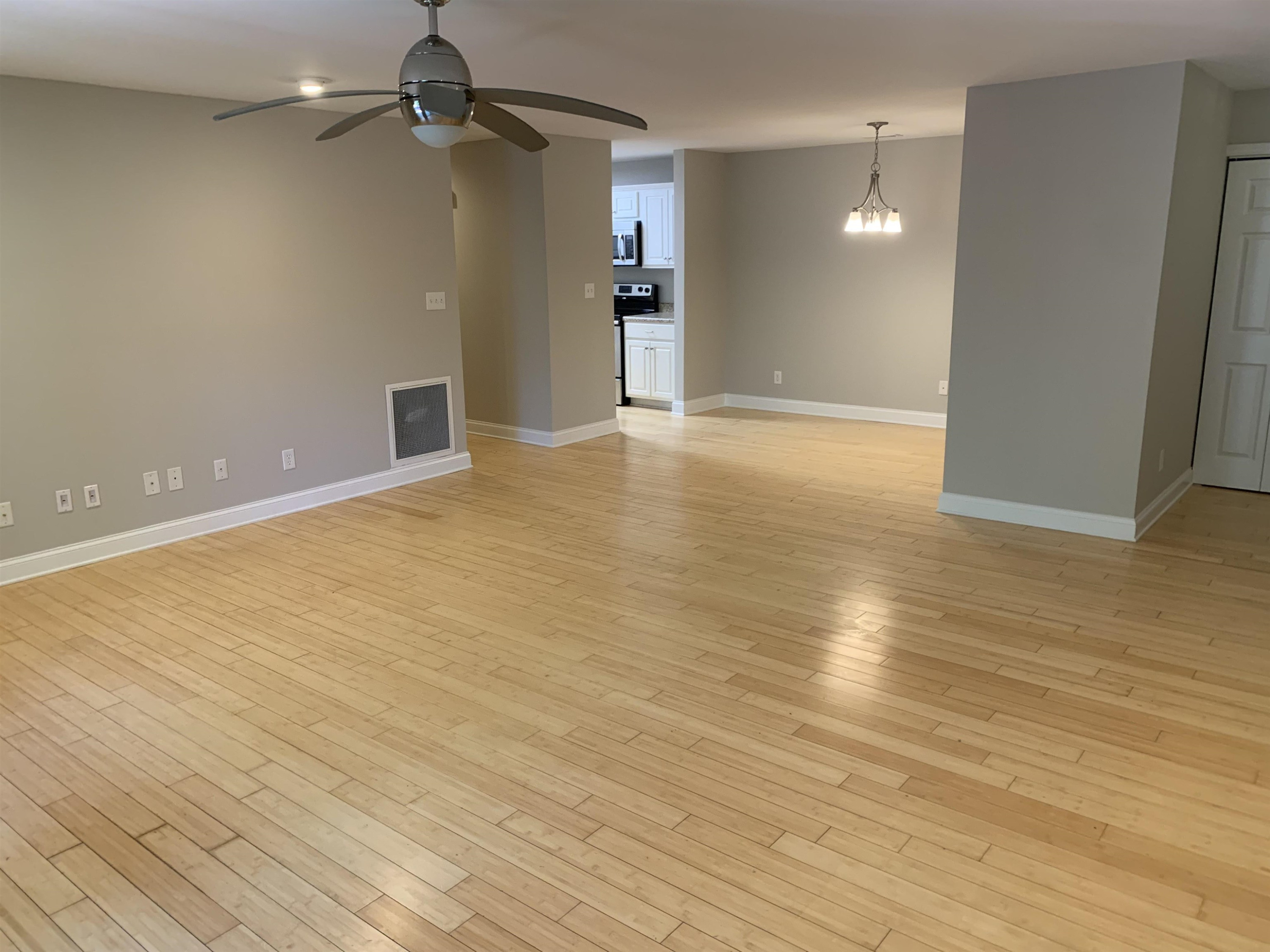 4505 Edwards Mill Road, Unit E Raleigh, NC 27612 - Photo 2 of 14 wooden floor in an empty room with a window
