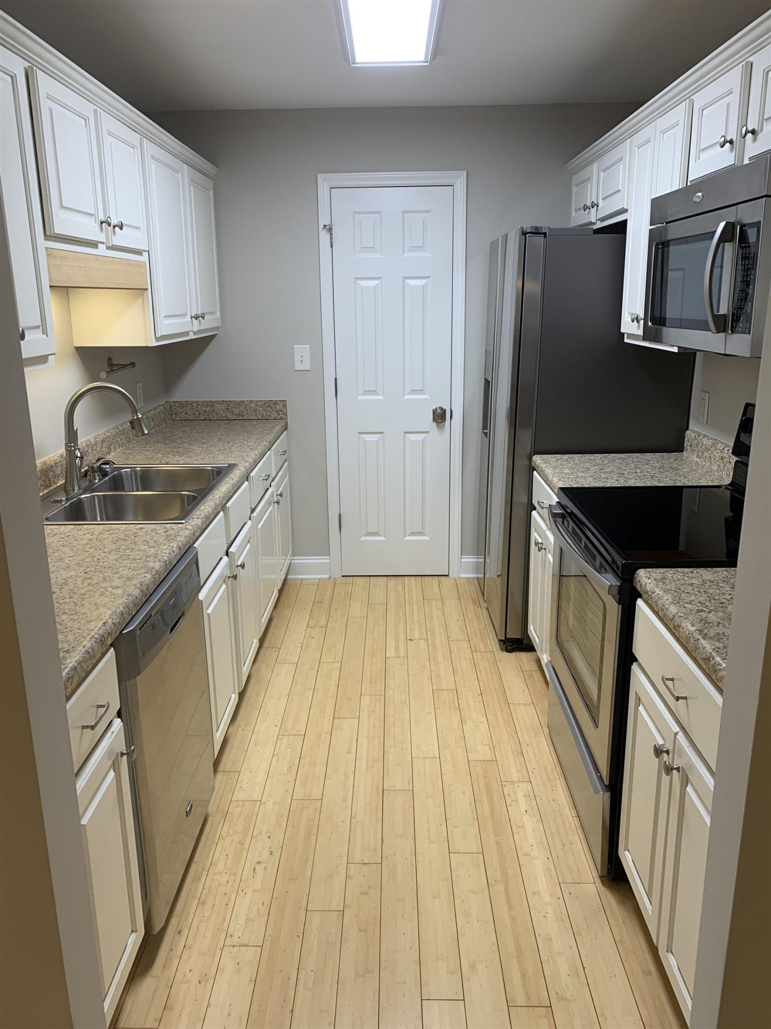 4505 Edwards Mill Road, Unit E Raleigh, NC 27612 - Photo 4 of 14 a kitchen with a sink stove and refrigerator