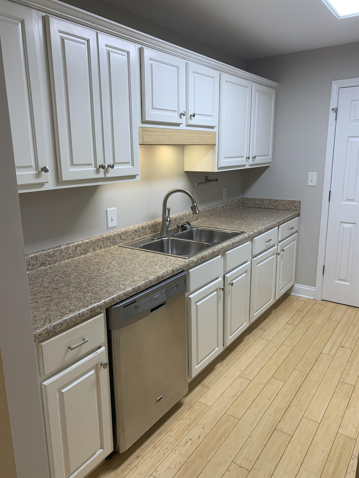 4505 Edwards Mill Road, Unit E Raleigh, NC 27612 - Photo 6 of 14 a kitchen with granite countertop a sink and cabinets