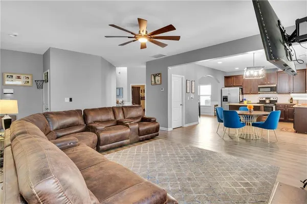 a living room with furniture and kitchen view