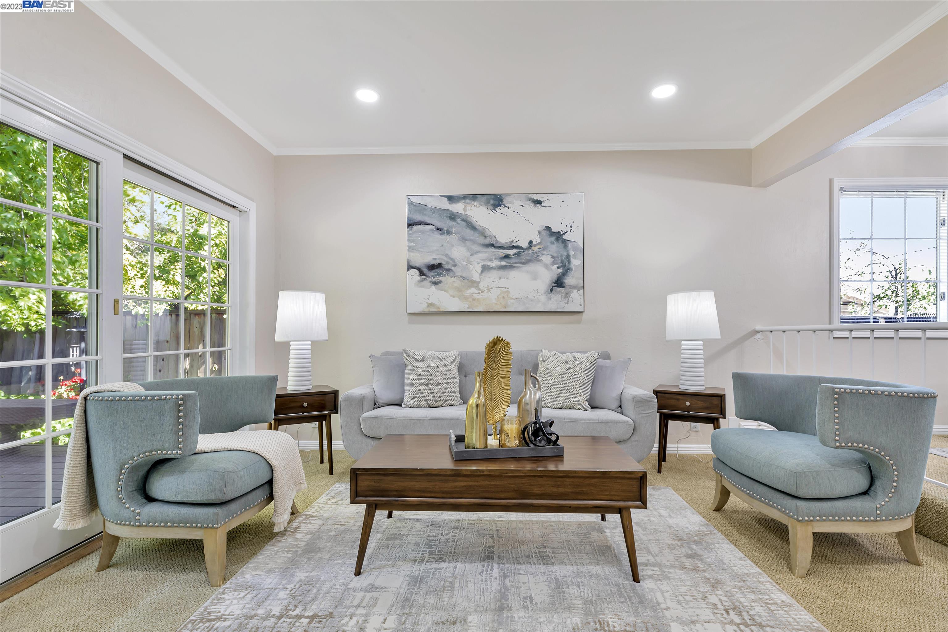 a living room with furniture a rug and a lamp