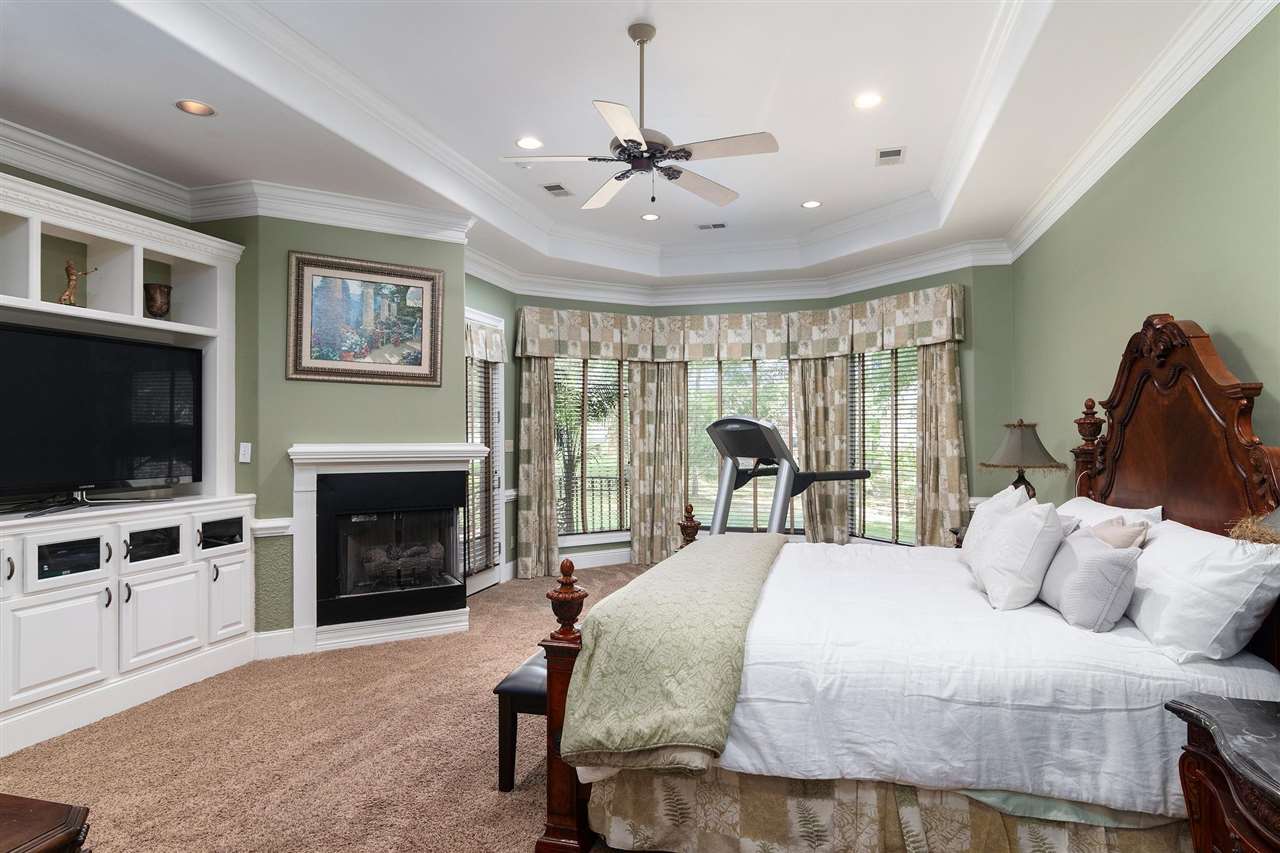9496 Mayfield Road South Collierville, TN 38017 - Photo 9 of 25 a spacious bedroom with a bed and a flat screen tv