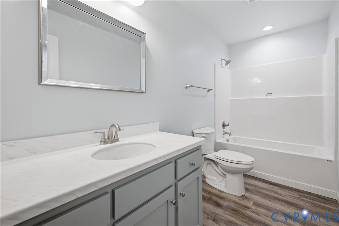 6019 Otterdam Road Waverly, VA 23890 - Photo 16 of 26 Vanity with gray cabinetry, integrated sink, and b