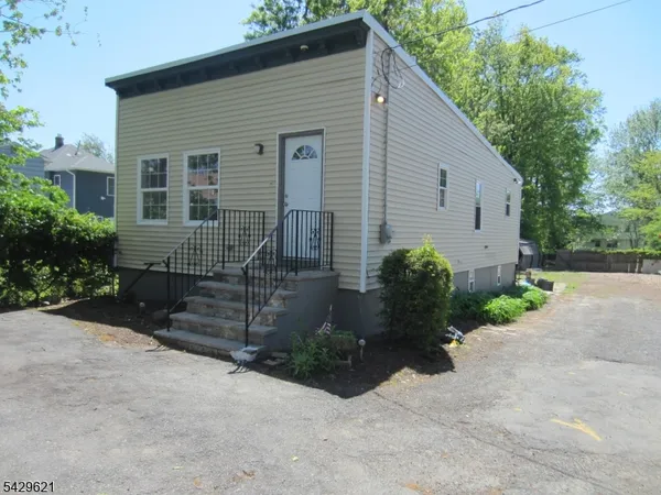 a view of a house with a yard and plants