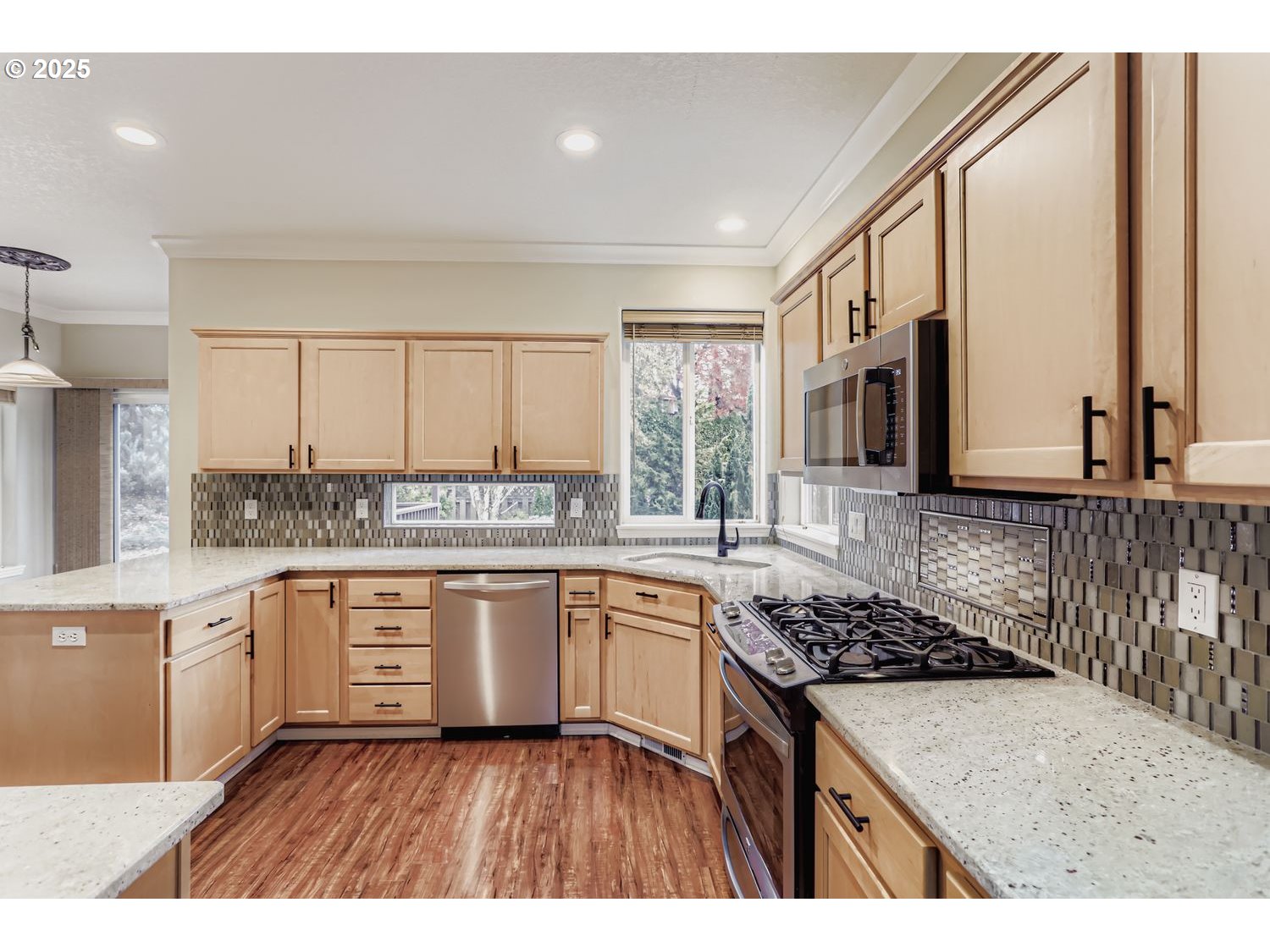12697 Southwest Canvasback Way Beaverton, OR 97007 - Photo 13 of 41 a kitchen with a stove a sink and a refrigerator
