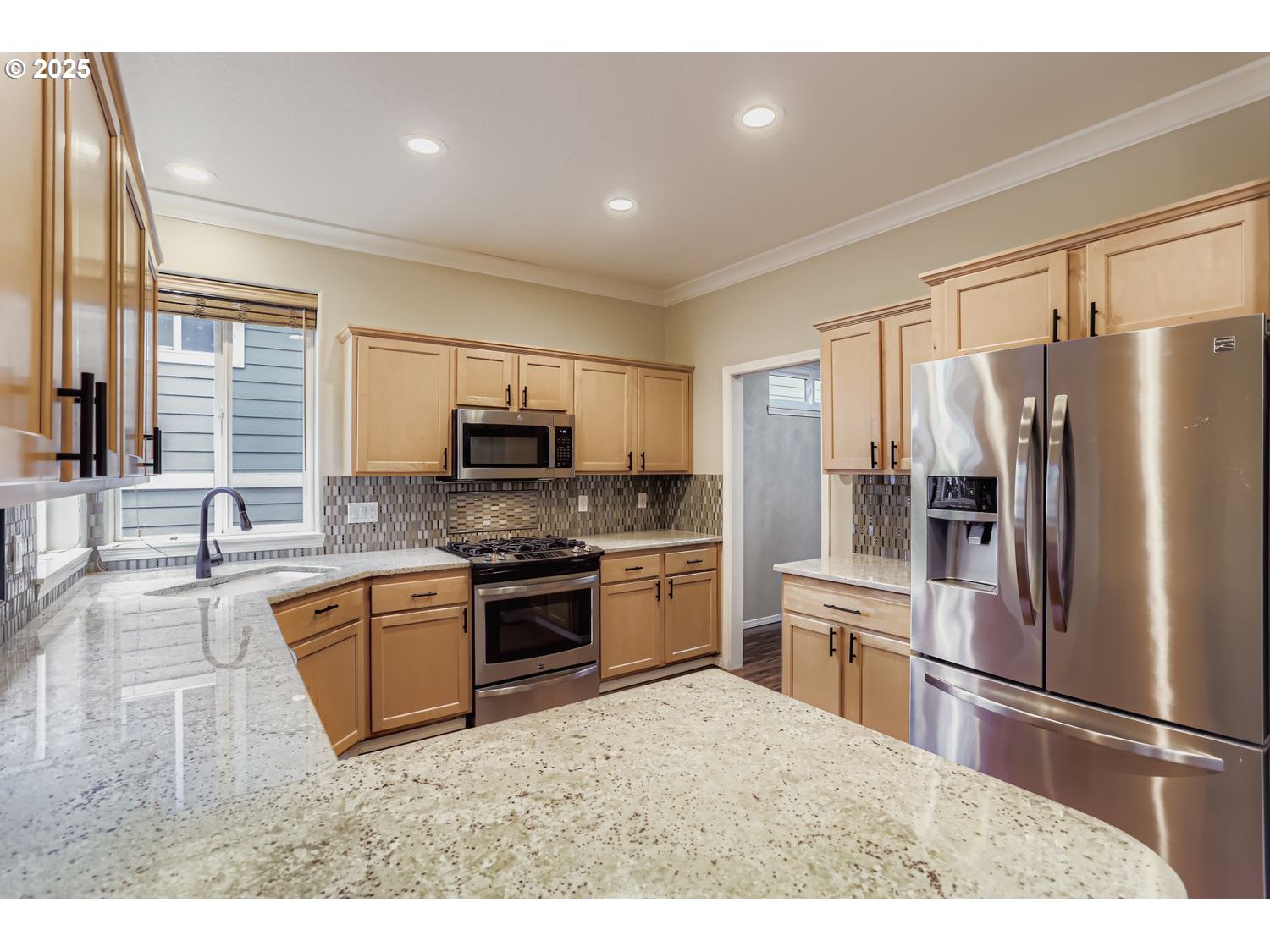 12697 Southwest Canvasback Way Beaverton, OR 97007 - Photo 14 of 41 a kitchen with granite countertop a refrigerator stove top oven and sink