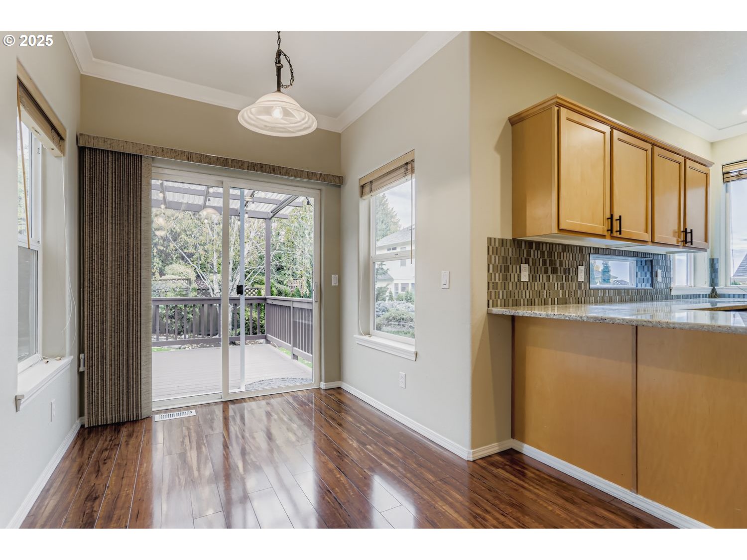 12697 Southwest Canvasback Way Beaverton, OR 97007 - Photo 16 of 41 a open hall with wooden floor and a kitchen space