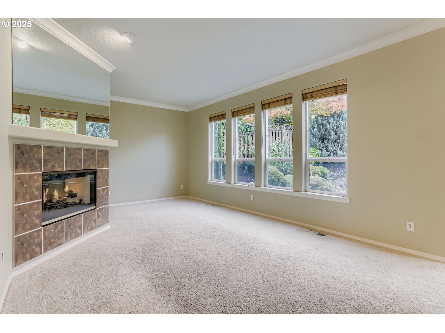 12697 Southwest Canvasback Way Beaverton, OR 97007 - Photo 17 of 41 a view of an empty room with a fireplace and a window