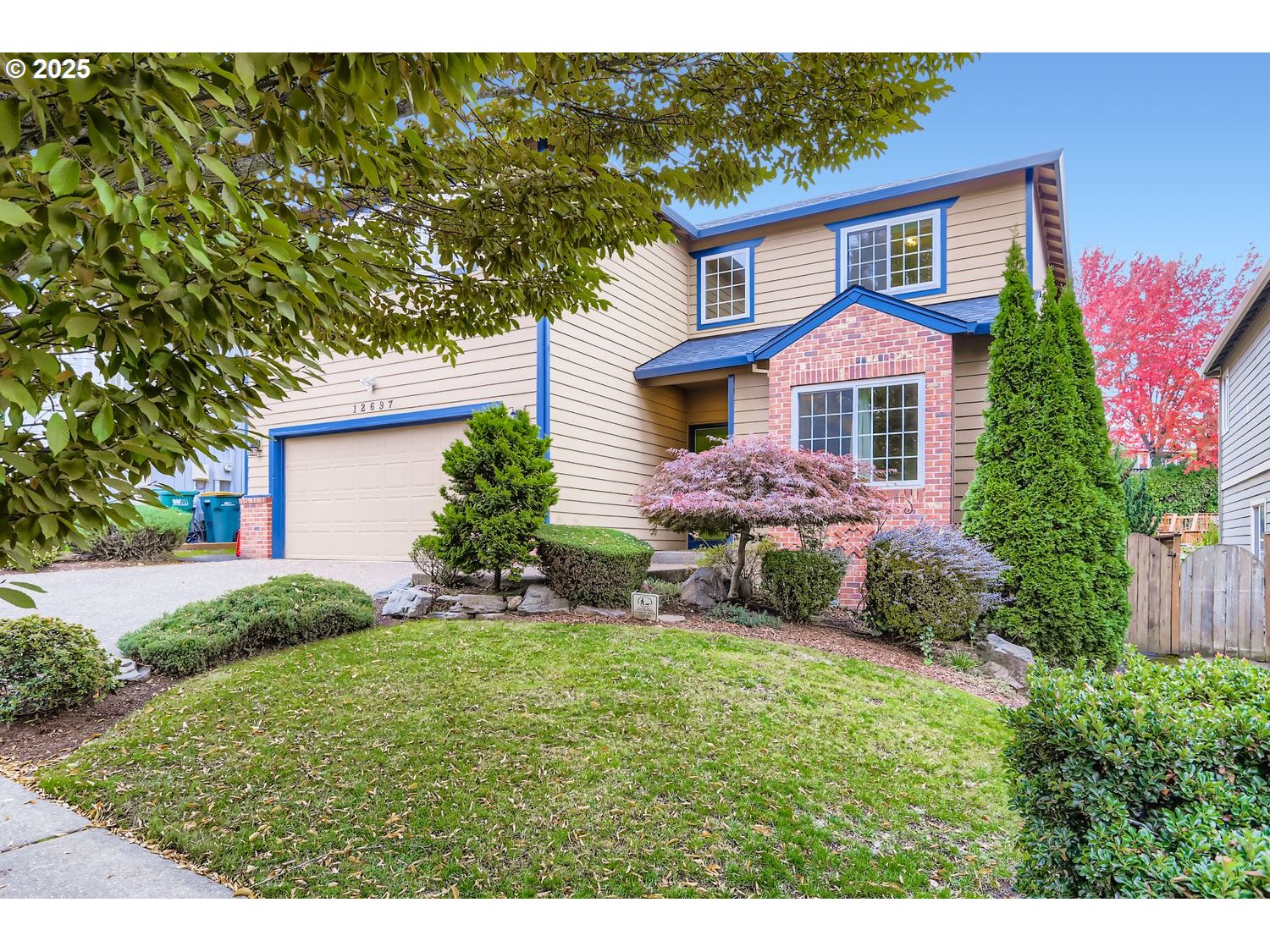12697 Southwest Canvasback Way Beaverton, OR 97007 - Photo 3 of 41 a front view of a house with a yard and garage