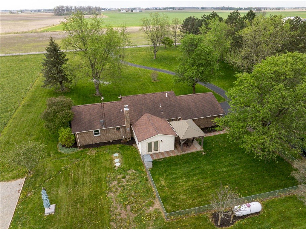 7988 McCool Road Greenville, OH 45331 - Photo 48 of 50 An aerial view captures this residence set amidst sprawling green fields and mature trees.