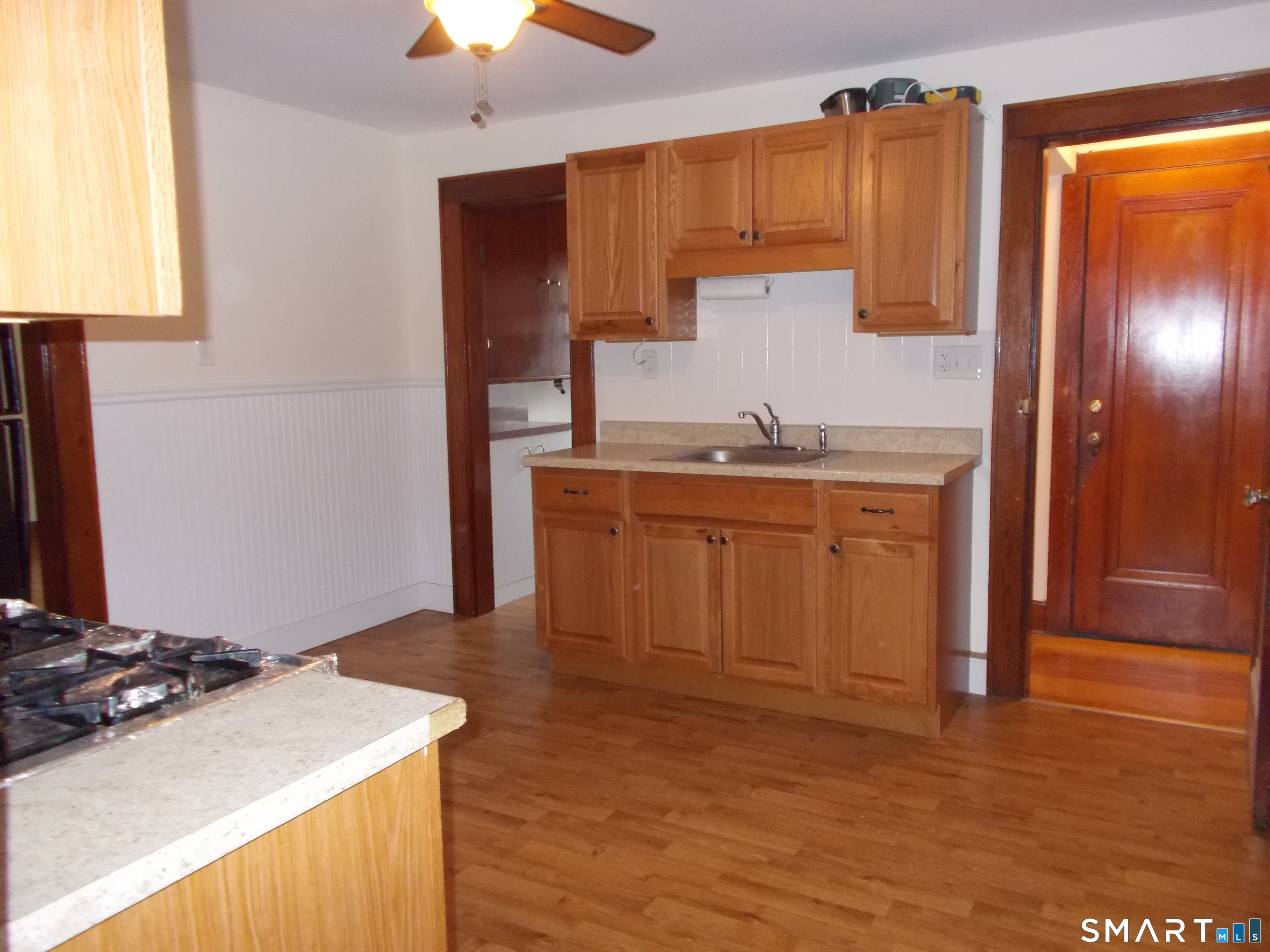 42 Holbrook Place, Unit 2 Ansonia, CT 06401 - Photo 7 of 12 a kitchen with a sink refrigerator and cabinets