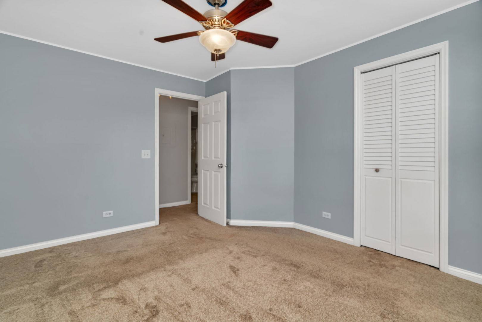 1332 McDowell Road, Unit 104 Naperville, IL 60563 - Photo 17 of 19 an empty room with closet and a chandelier fan