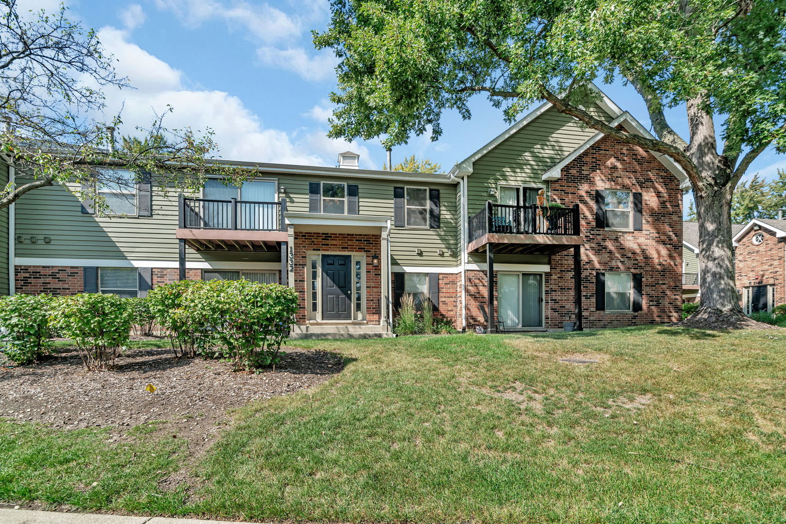 1332 McDowell Road, Unit 104 Naperville, IL 60563 - Photo 18 of 19 a view of house with outdoor space and garden