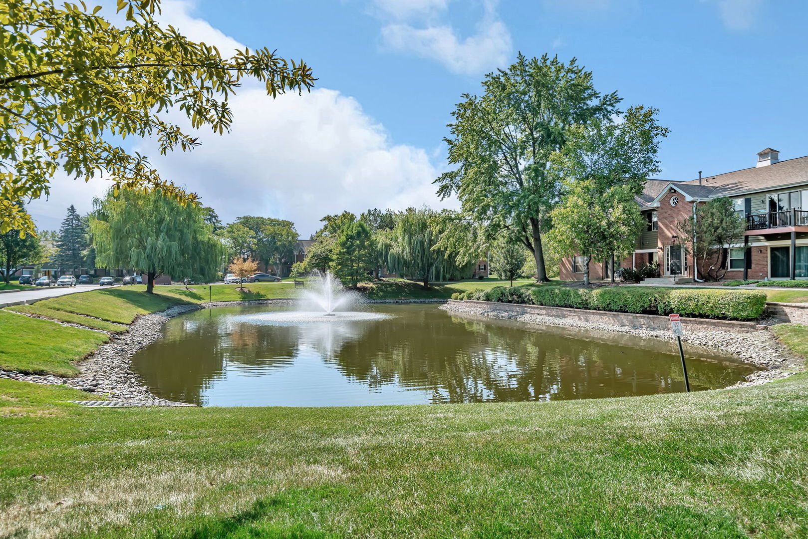 1332 McDowell Road, Unit 104 Naperville, IL 60563 - Photo 19 of 19 a view of a swimming pool with a yard and plants