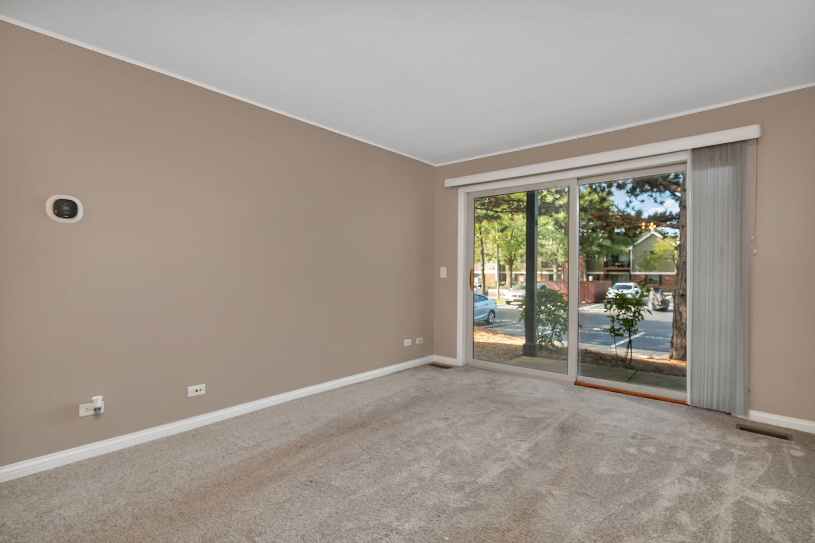 1332 McDowell Road, Unit 104 Naperville, IL 60563 - Photo 6 of 19 a view of an empty room with wooden floor and a window