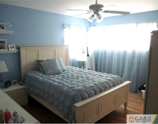 81 Princeton Road Old Bridge, NJ 08859 - Photo 5 of 15 a bedroom with a bed and a chandelier