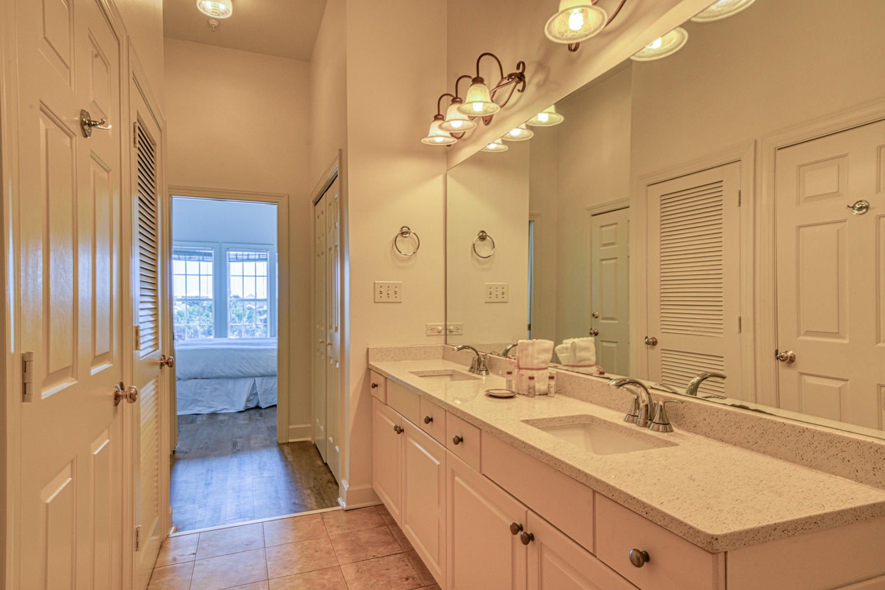 10343 East County Highway 30A, Unit 307 Seacrest, FL 32413 - Photo 20 of 34 a spacious bathroom with a granite countertop sink a toilet a mirror and shower