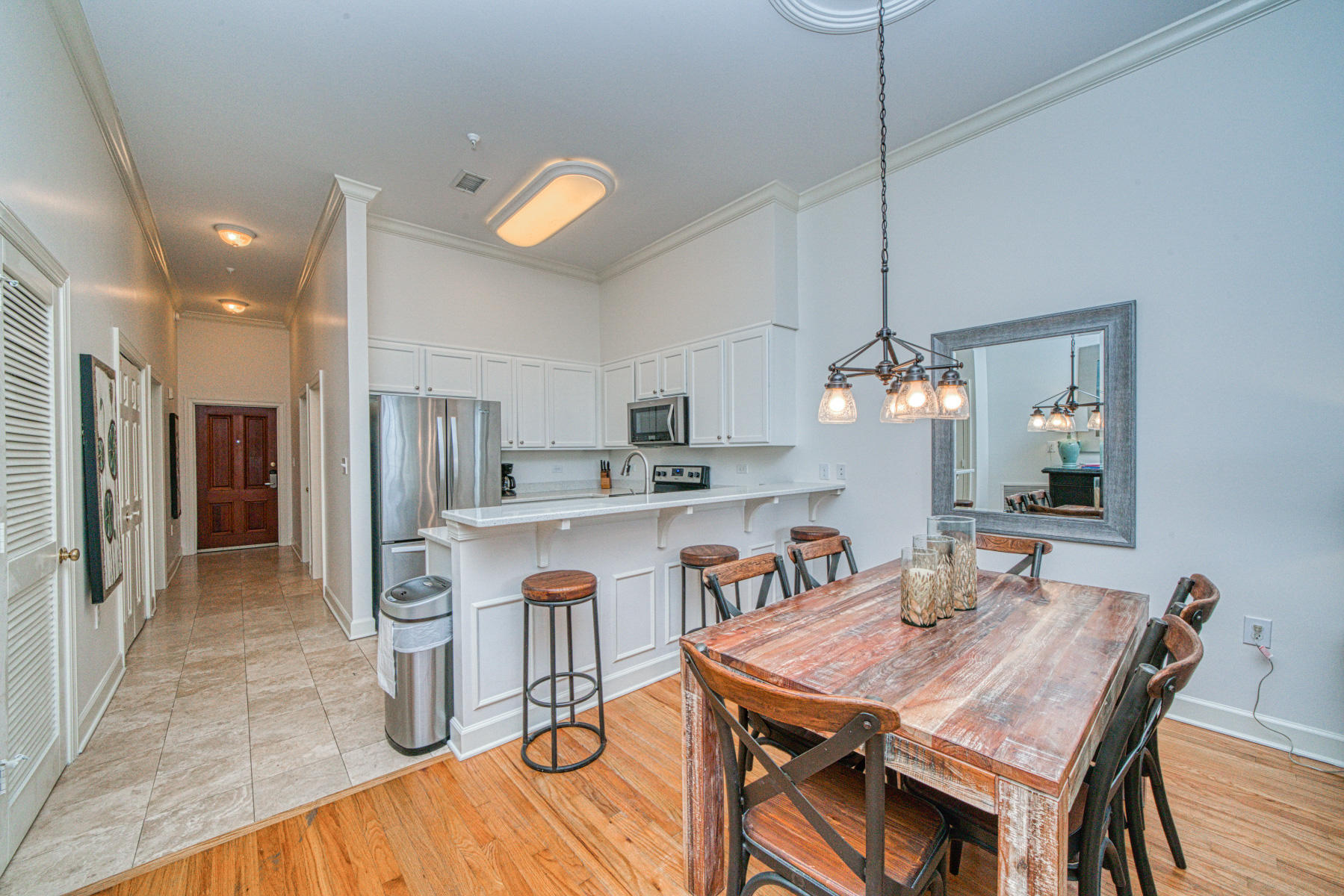 10343 East County Highway 30A, Unit 307 Seacrest, FL 32413 - Photo 7 of 34 a view of a dining room and a kitchen with a table chairs