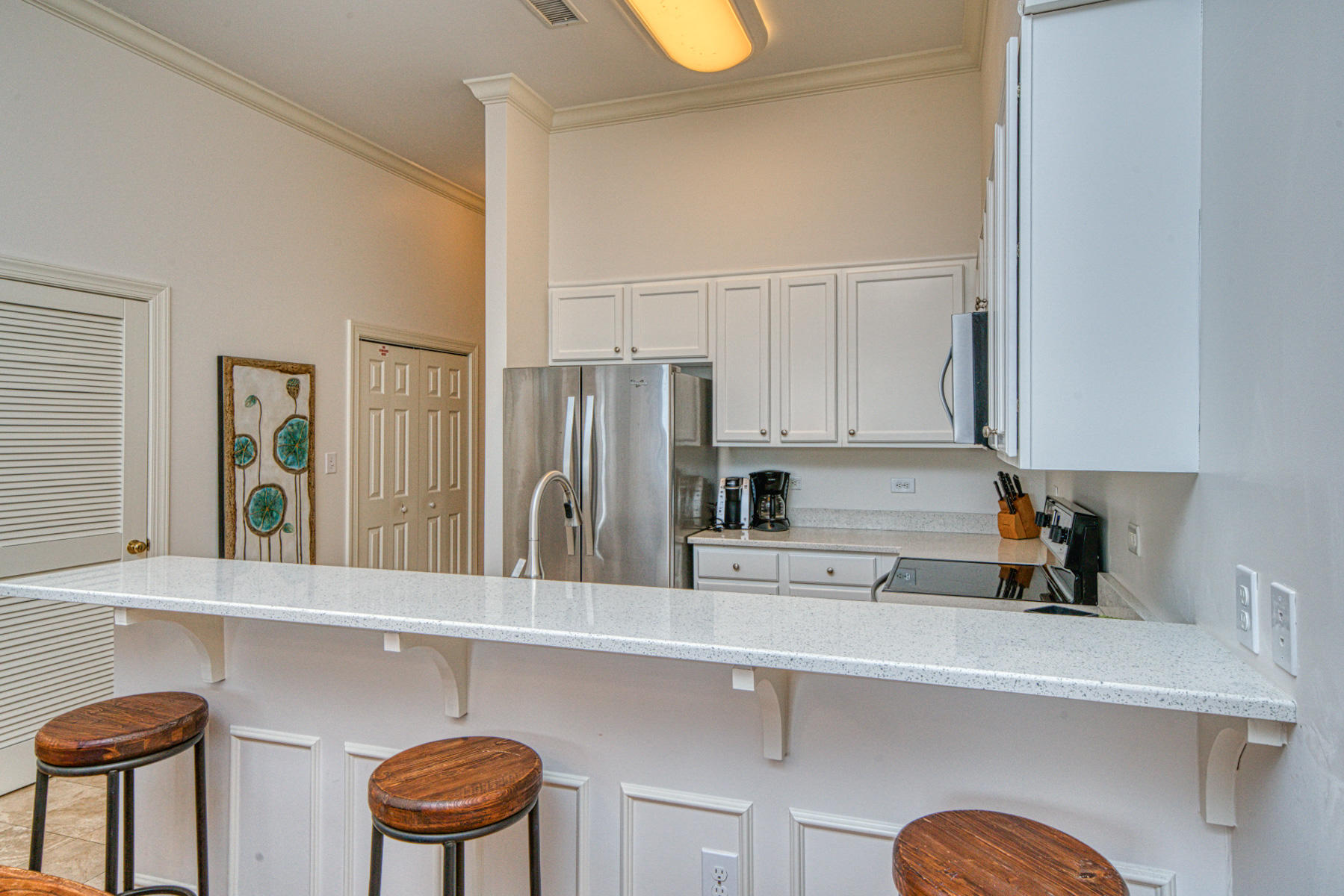 10343 East County Highway 30A, Unit 307 Seacrest, FL 32413 - Photo 8 of 34 a kitchen with stainless steel appliances a sink a refrigerator and cabinets