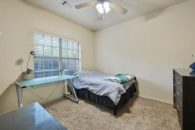 a bed sitting in a bedroom next to a window